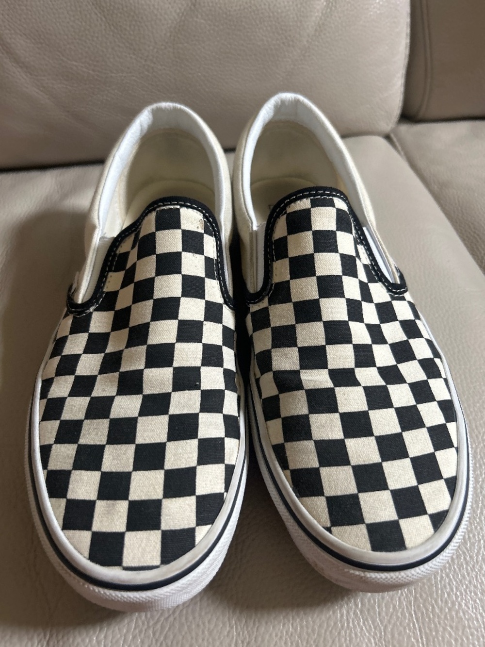 Checkered black and white slip ons vans